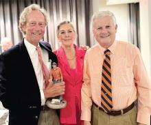 Craig Garnett (left), joined by wife Melissa Garnett, accepted the International Society of Weekly Newspaper Editors’ Eugene Cervi award at the organization’s annual conference in Cardiff, Wales, held July 15-19. At right is Chad Stebbins, executive director of the Missouri Press Association and ISWNE.