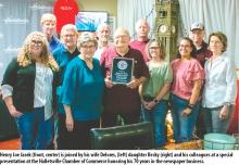 Henry Joe Jasek (front, center) is joined by his wife Delores, (left) daughter Becky (right) and his colleagues at a special presentation at the Halletsville Chamber of Commerce honoring his 70 years in the newspaper business.